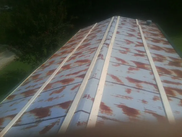 Rusted metal roof panels with new wood purlins before replacement — Storm Damage Roof Repair in Roxbury by Roofing Brothers